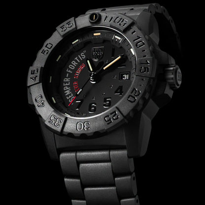 A black tactical-style LUMINOX WATCH שעון לומינוקס analog watch with a matching black metal link bracelet, featuring a dark dial with green, orange, and white markings and the text 'SEMPER FORTIS' and 'EVER STRON