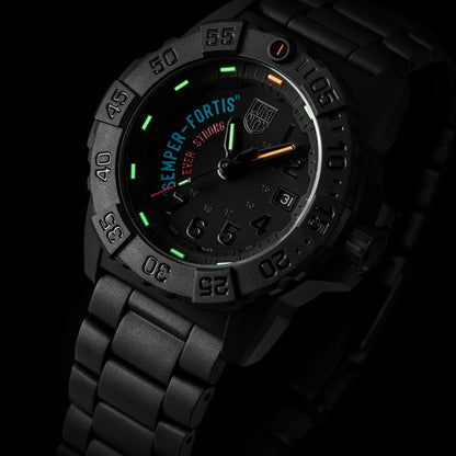 A black tactical-style LUMINOX WATCH שעון לומינוקס analog watch with a matching black metal link bracelet, featuring a dark dial with green, orange, and white markings and the text 'SEMPER FORTIS' and 'EVER STRONG